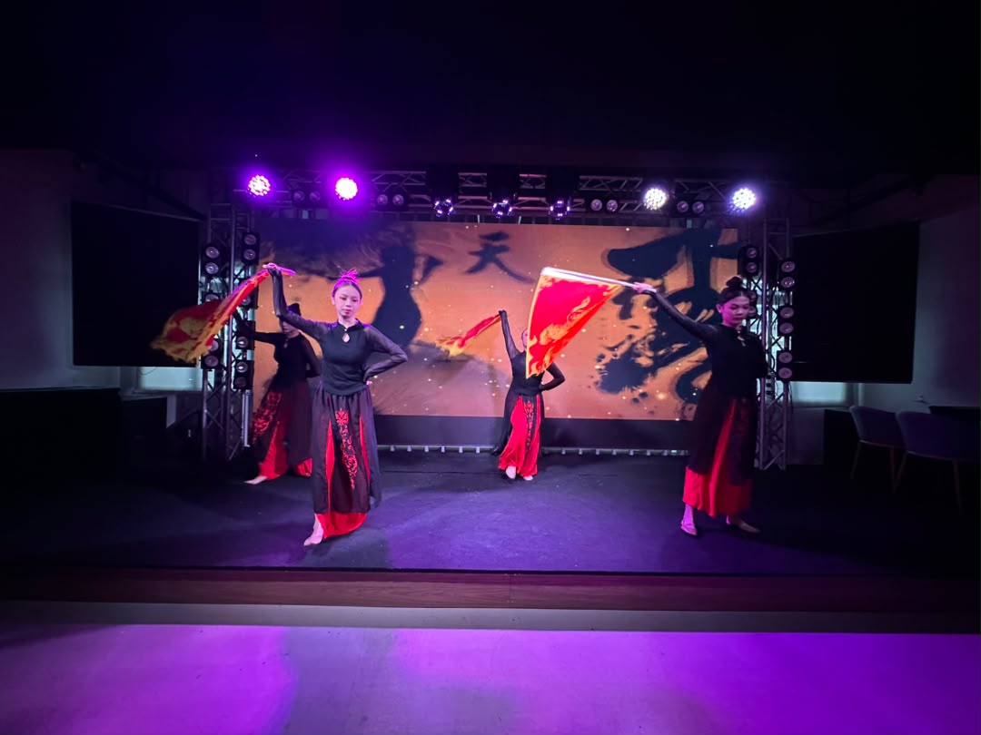 Dance performance on stage with purple event lighting at Dreamlive Event Space Puchong