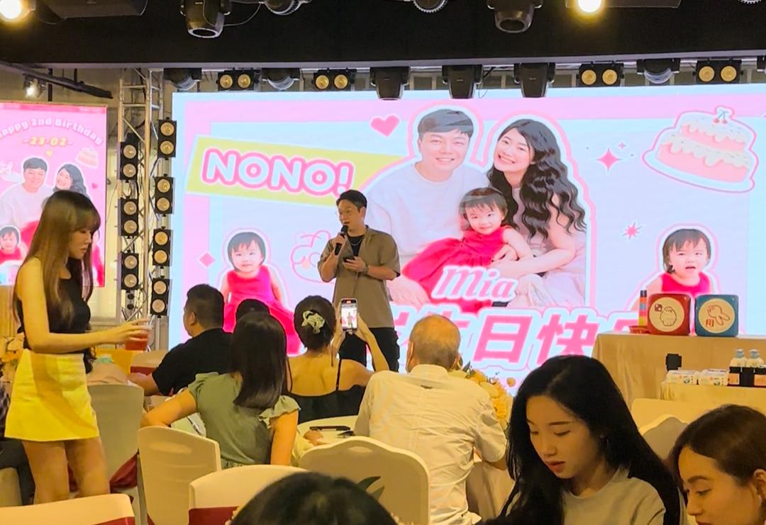 Birthday party with emcee on stage and guests at banquet tables at Dreamlive Event Space Puchong