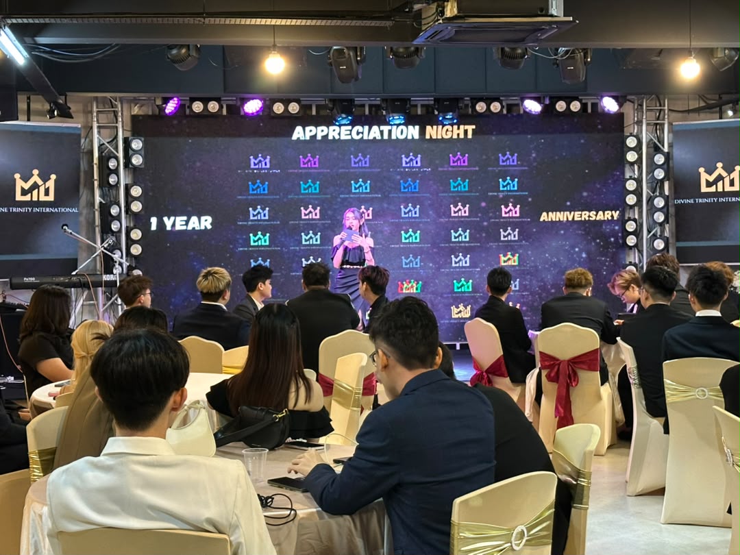 Team members receiving awards on stage during a company anniversary night in Puchong