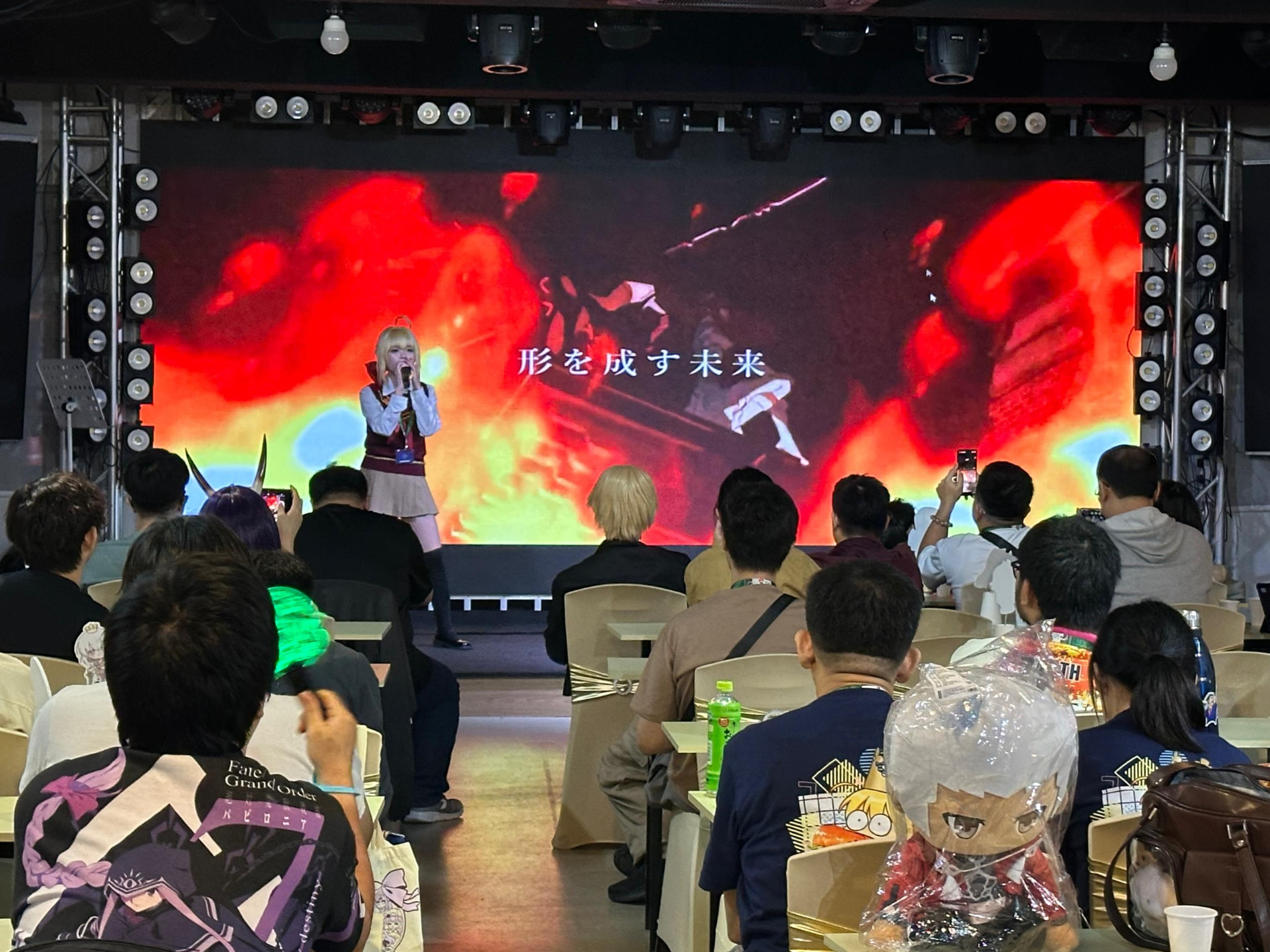 Cosplay singer performing on stage in front of anime fans at a community event at Dreamlive Event Space Puchong