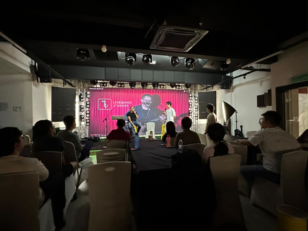 Community fan gathering watching a live-streamed interview at Dreamlive Event Space Puchong
