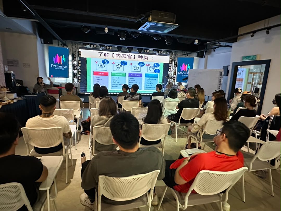 Workshop in progress with participants seated facing the large LED screen at Dreamlive Event Space Puchong