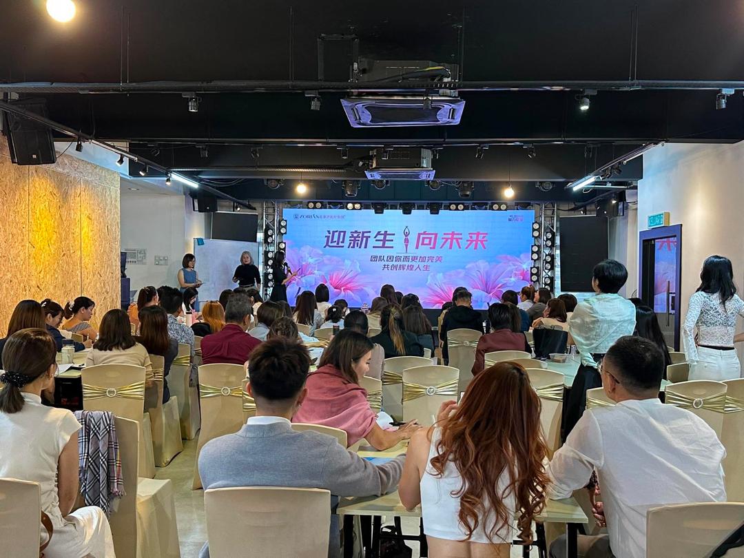 Training seminar with speakers on stage and a full audience facing the LED screen at Dreamlive Event Space Puchong