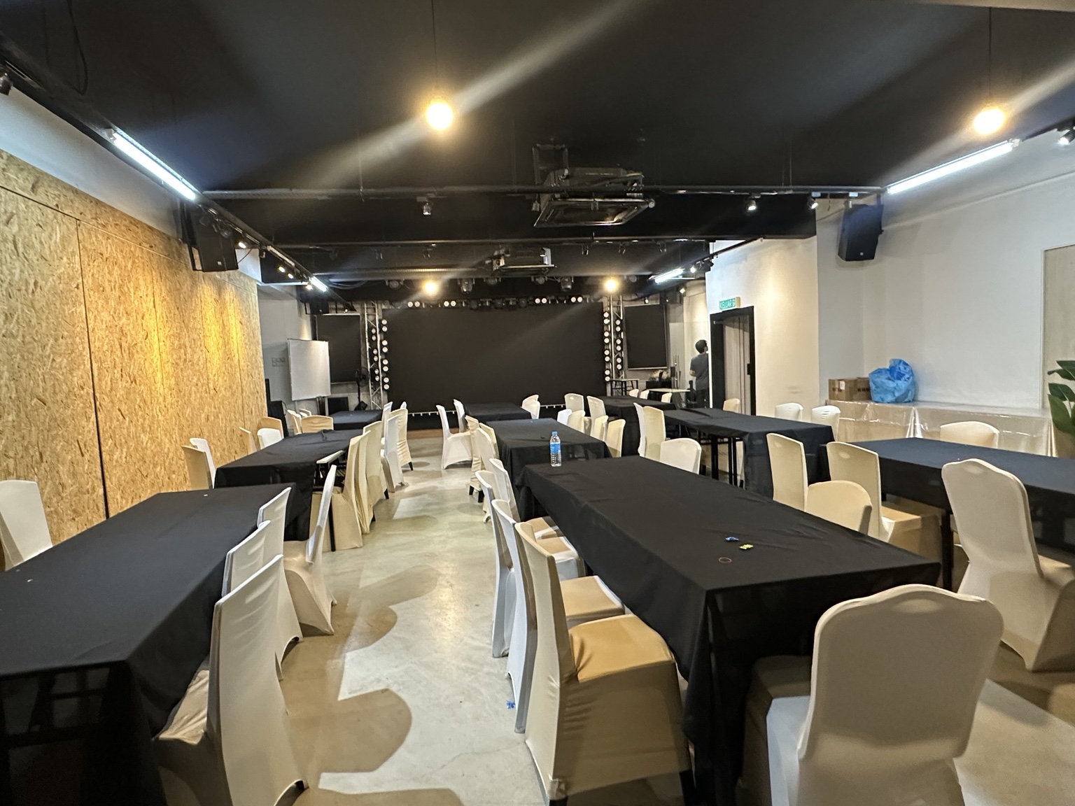 Long table setup with black rectangular tables arranged lengthwise at Dreamlive Event Space