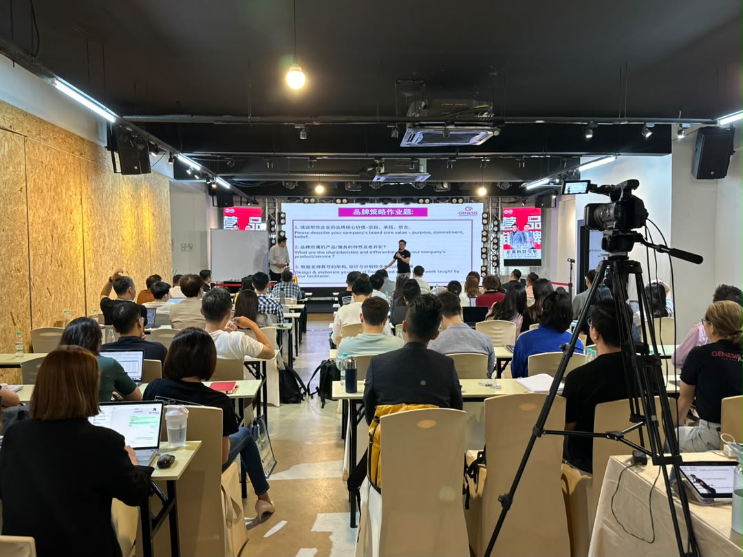 Large training programme with participants at classroom tables facing the LED screen at Dreamlive Event Space Puchong
